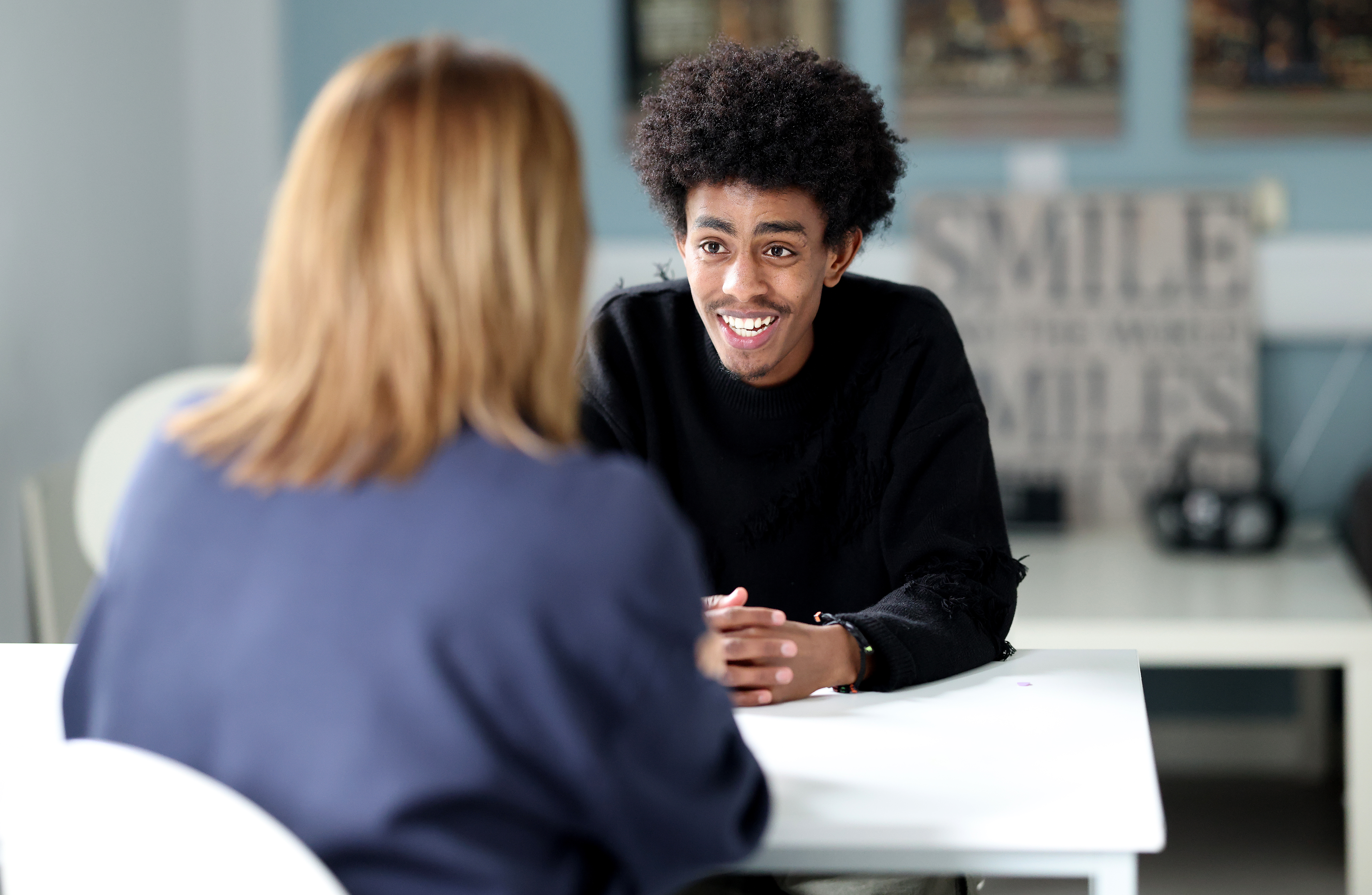 Young man chatting to Riverside colleague