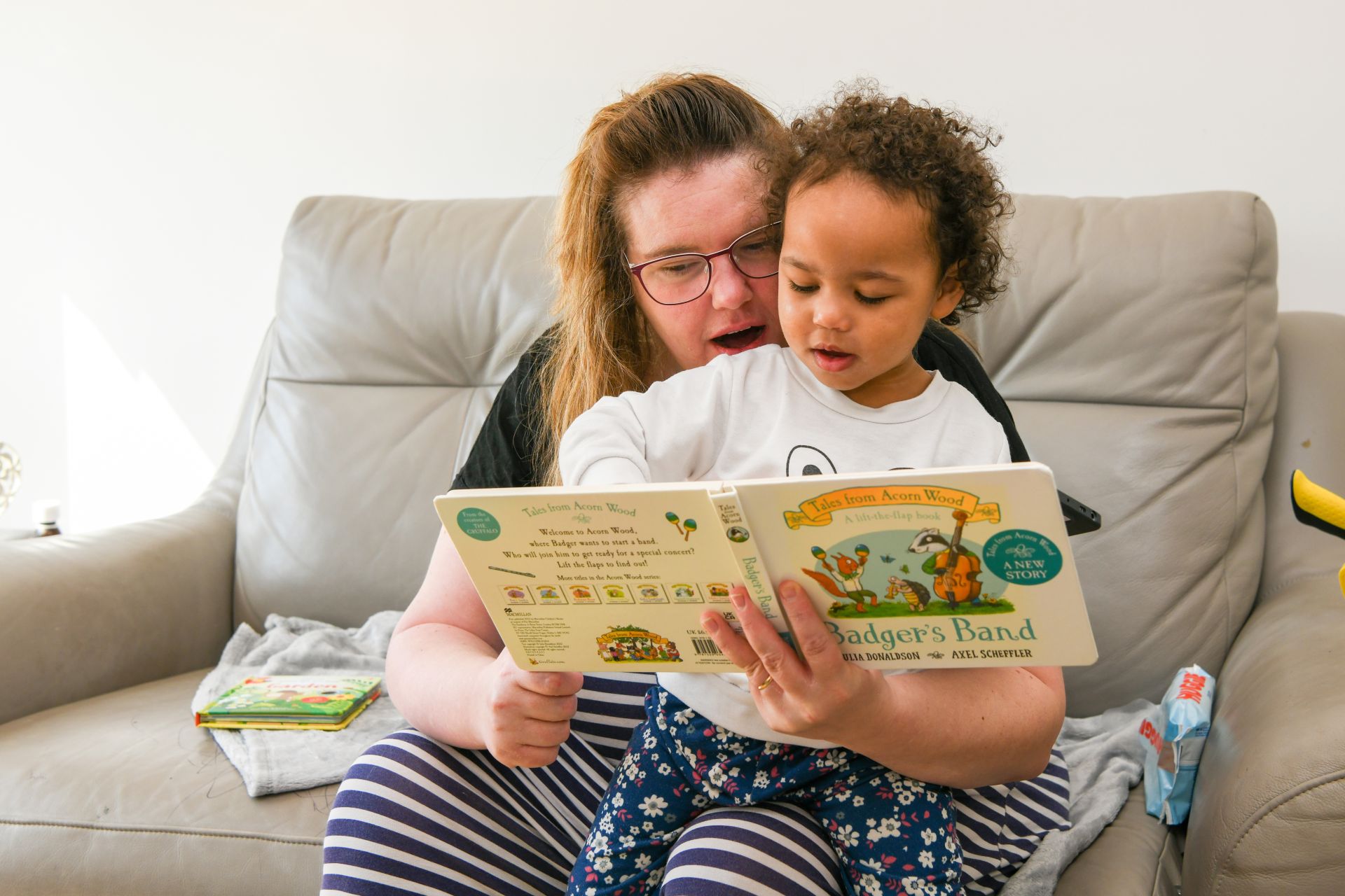lady holding baby reading book